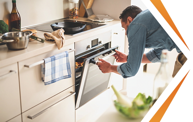 man checking oven